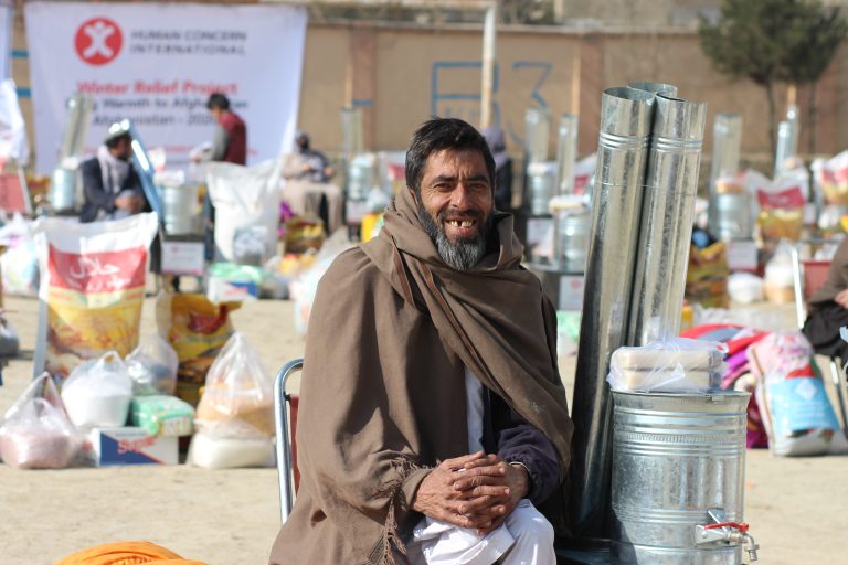 Afghani man draped in a thick shawl during the winter months.