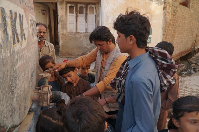 Community retrieve water from a recently installed water facility in Pakistan.