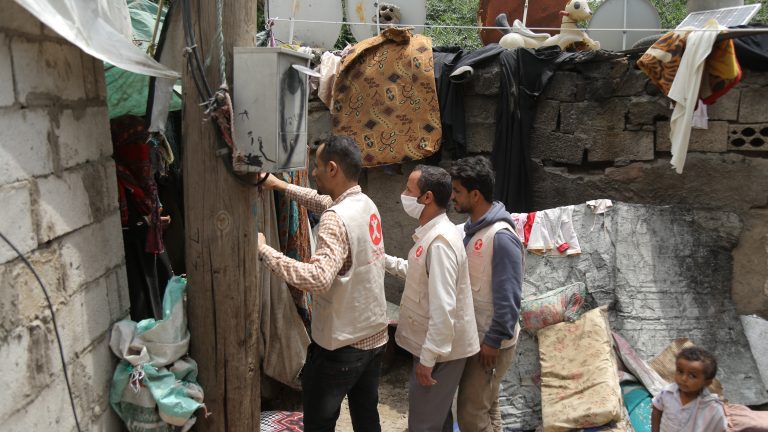 HCI Aid Workers deliver aid to a woman in her home.