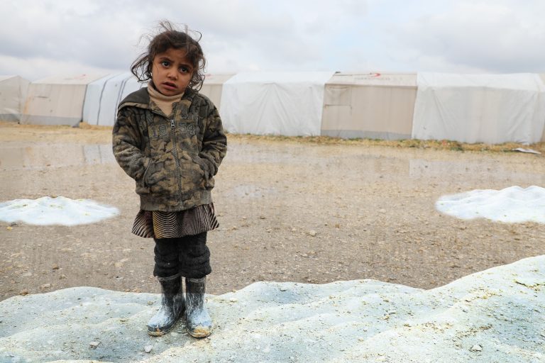 Syrian girl out in the open, affected by the harsh elements.